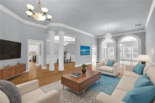 a living room with furniture a large window and a flat screen tv