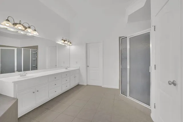 a bathroom with a double vanity sink and mirror