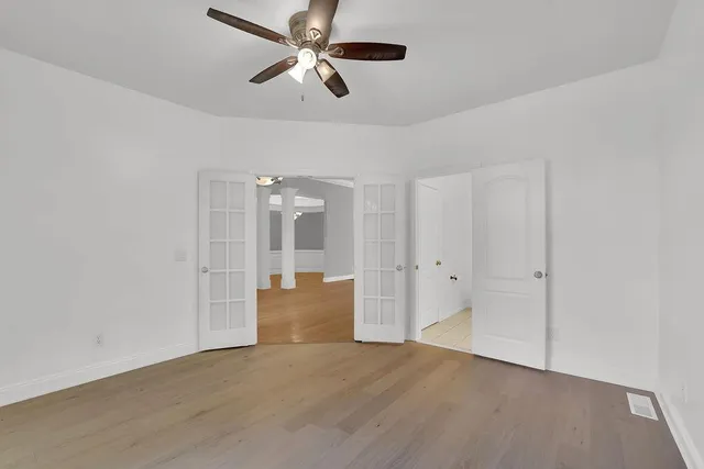 an empty room with fan and ceiling fan
