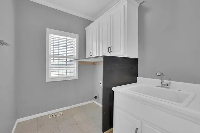 a bathroom with a sink and cabinets