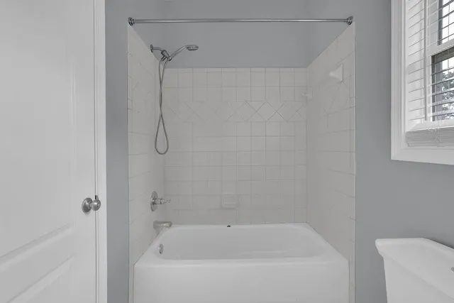 a bathroom with a bathtub and a shower