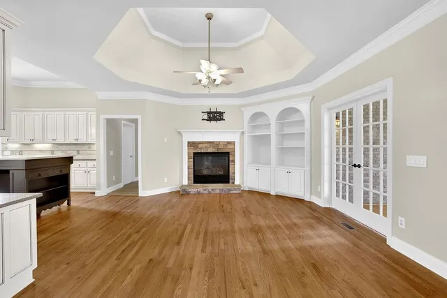 a view of an empty room with a fireplace and a window