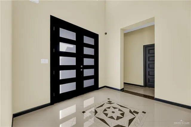 a view of a bedroom with wooden floor