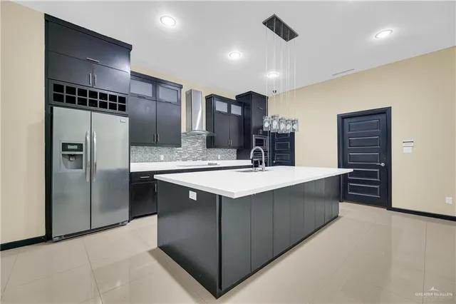 a kitchen with stainless steel appliances a sink and a refrigerator