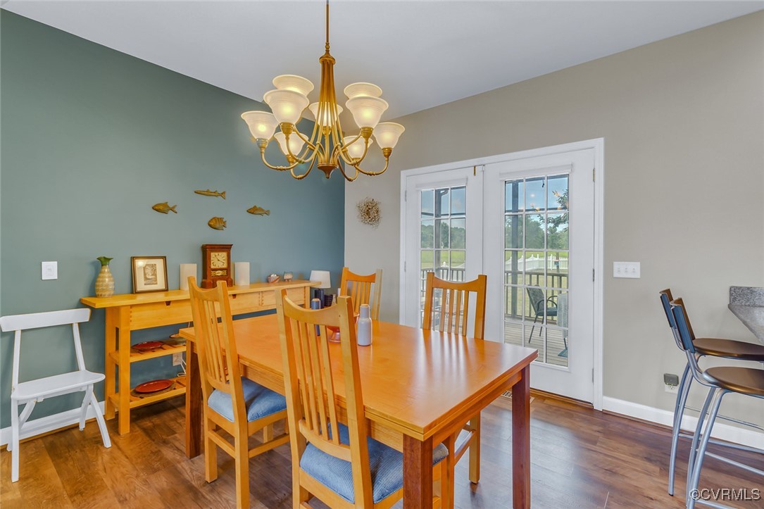 324 Potomac Drive Heathsville, VA 22473 - Photo 20 of 50 a view of a dining room with furniture wooden floor and chandelier