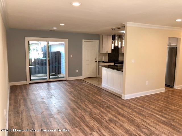 9 Swan Road, Unit 1000 Howell, NJ 07731 - Photo 2 of 13 a view of a kitchen with wooden floor and electronic appliances