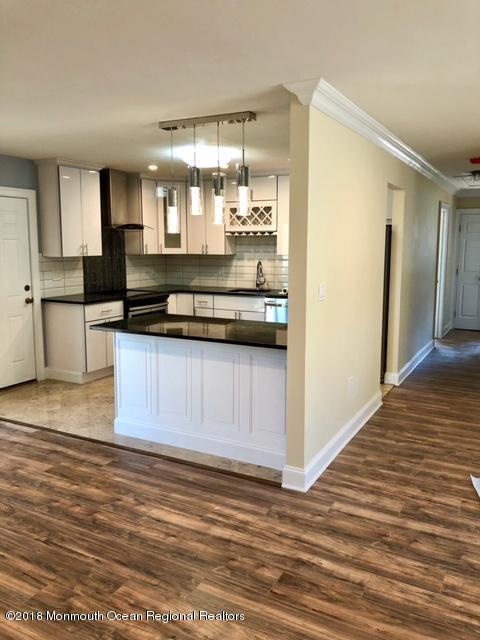 9 Swan Road, Unit 1000 Howell, NJ 07731 - Photo 3 of 13 a kitchen with stainless steel appliances granite countertop a stove a sink and a refrigerator