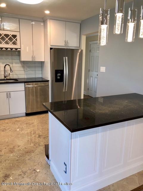 9 Swan Road, Unit 1000 Howell, NJ 07731 - Photo 5 of 13 a kitchen with stainless steel appliances granite countertop a sink a stove a refrigerator and cabinets
