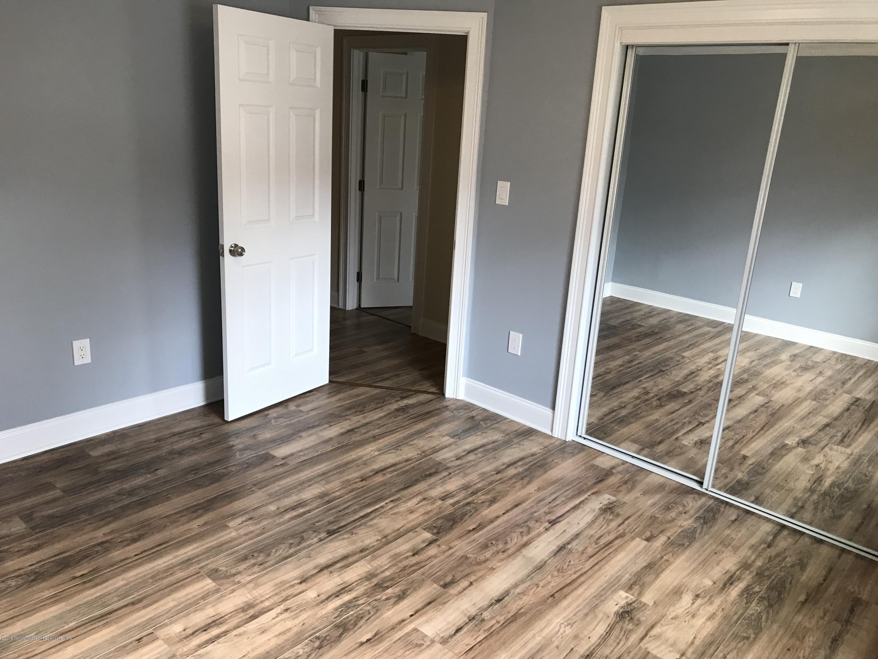 9 Swan Road, Unit 1000 Howell, NJ 07731 - Photo 6 of 13 a view of a hallway with wooden floor