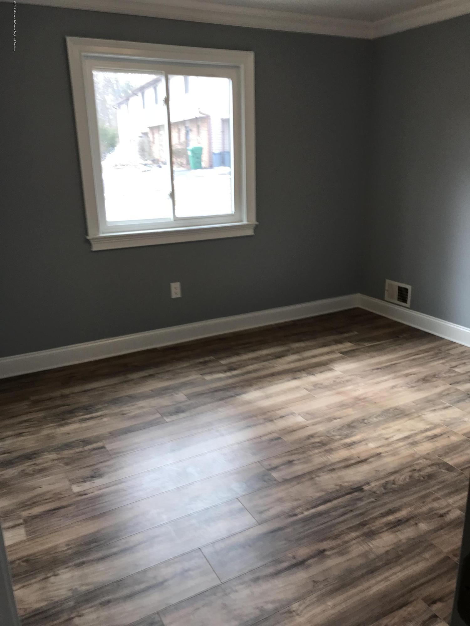 9 Swan Road, Unit 1000 Howell, NJ 07731 - Photo 7 of 13 a view of empty room with wooden floor and fan