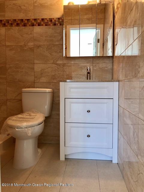9 Swan Road, Unit 1000 Howell, NJ 07731 - Photo 10 of 13 a bathroom with a toilet a sink and mirror