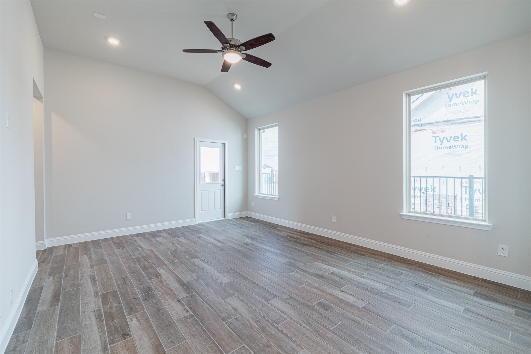 12611 White Pelican Court Cypress, TX 77433 - Photo 12 of 24 an empty room with wooden floor and windows