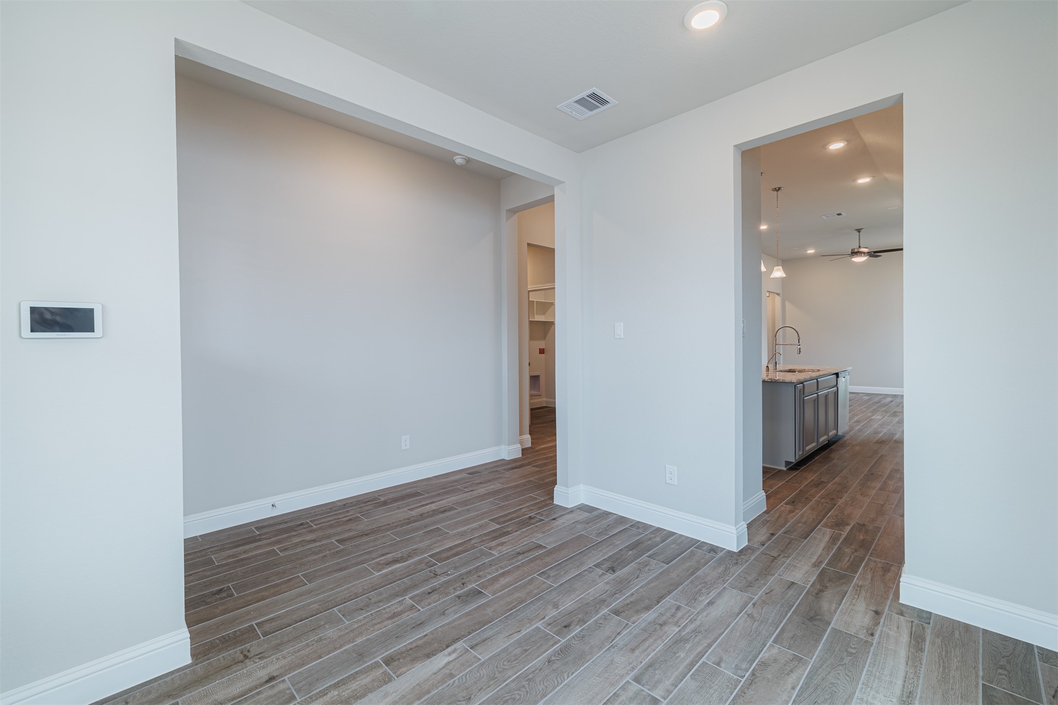12611 White Pelican Court Cypress, TX 77433 - Photo 13 of 24 a view of a hallway with wooden floor