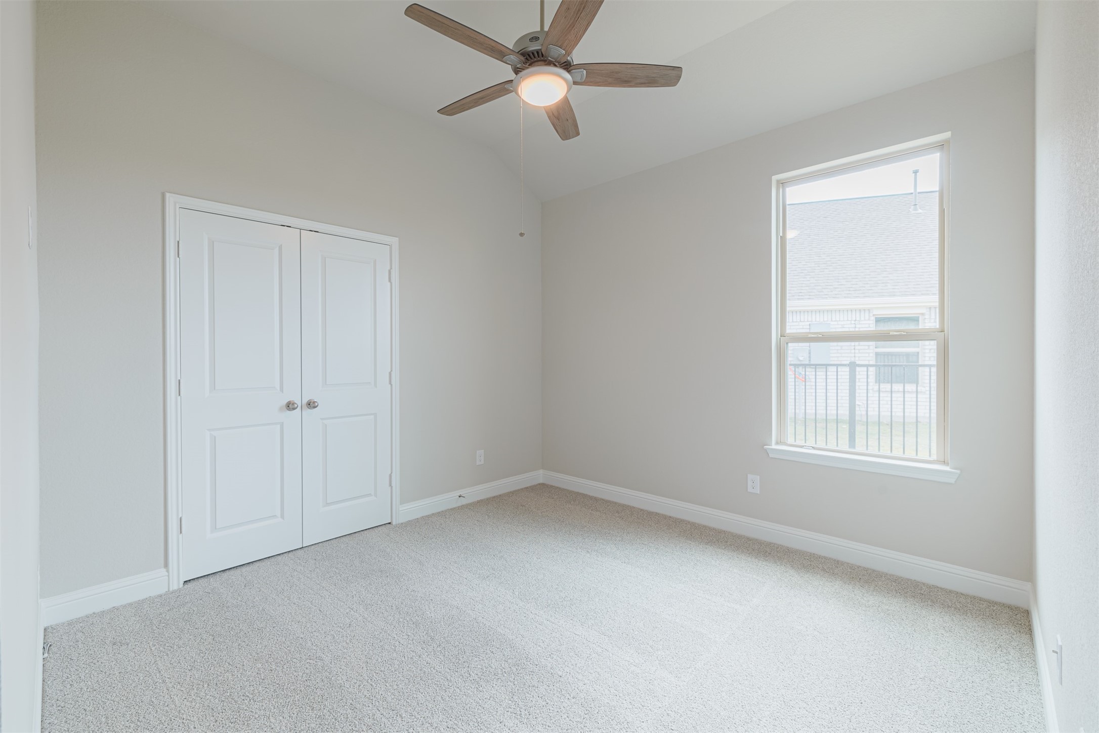 12611 White Pelican Court Cypress, TX 77433 - Photo 14 of 24 an empty room with chandelier fan and windows