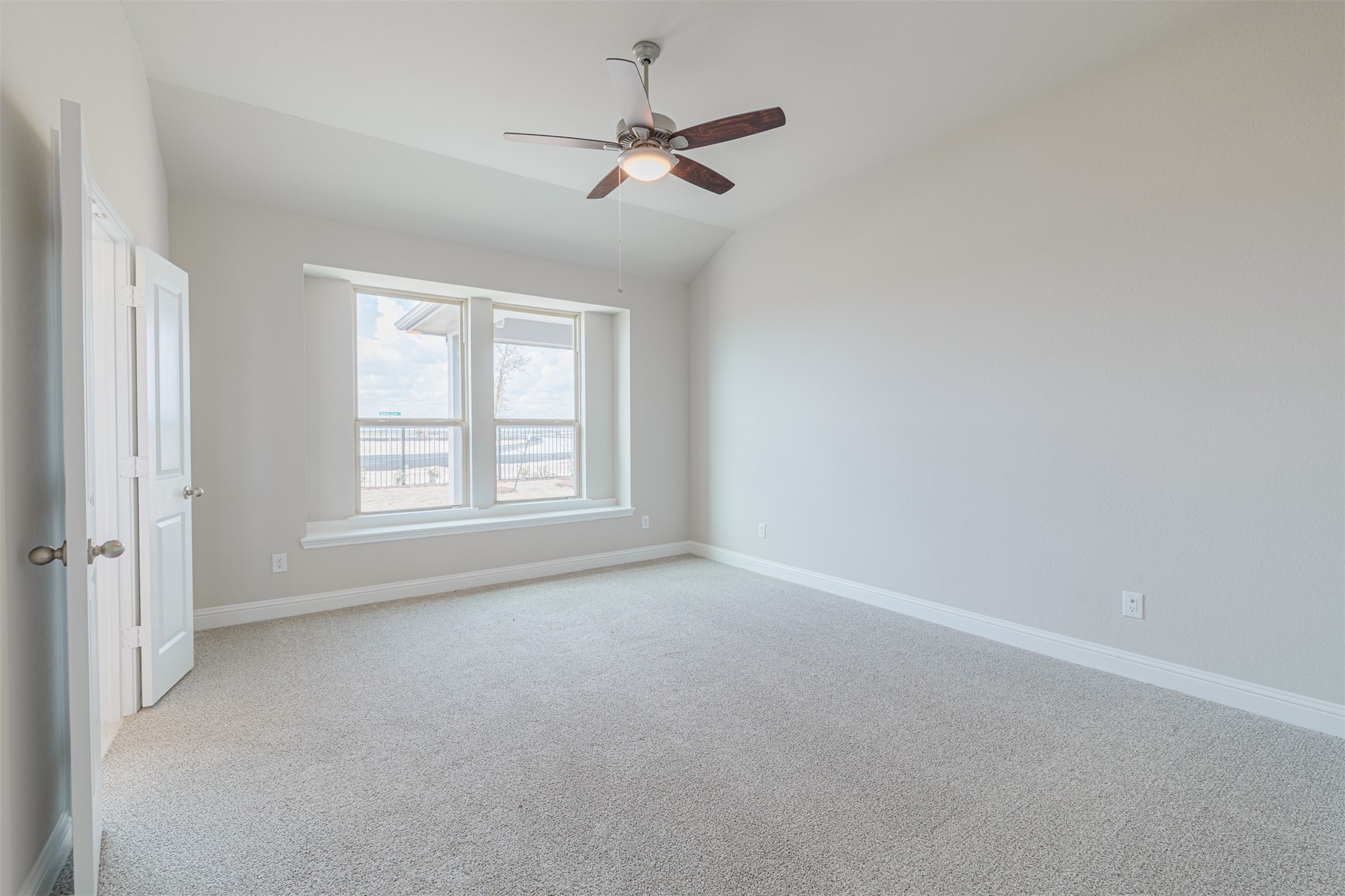 12611 White Pelican Court Cypress, TX 77433 - Photo 21 of 24 an empty room with a ceiling fan and window