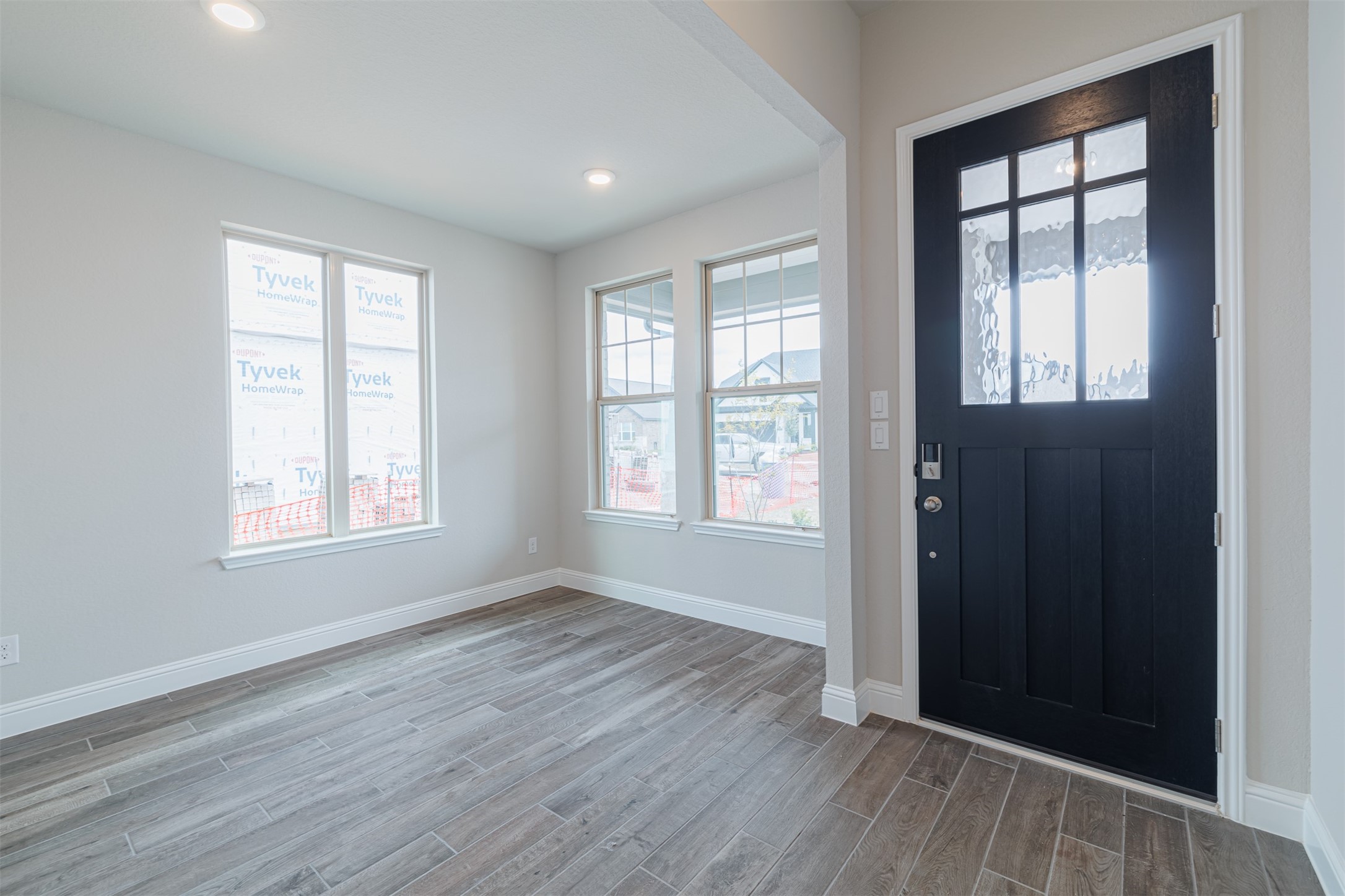 12611 White Pelican Court Cypress, TX 77433 - Photo 4 of 24 a view of an empty room with wooden floor and a window