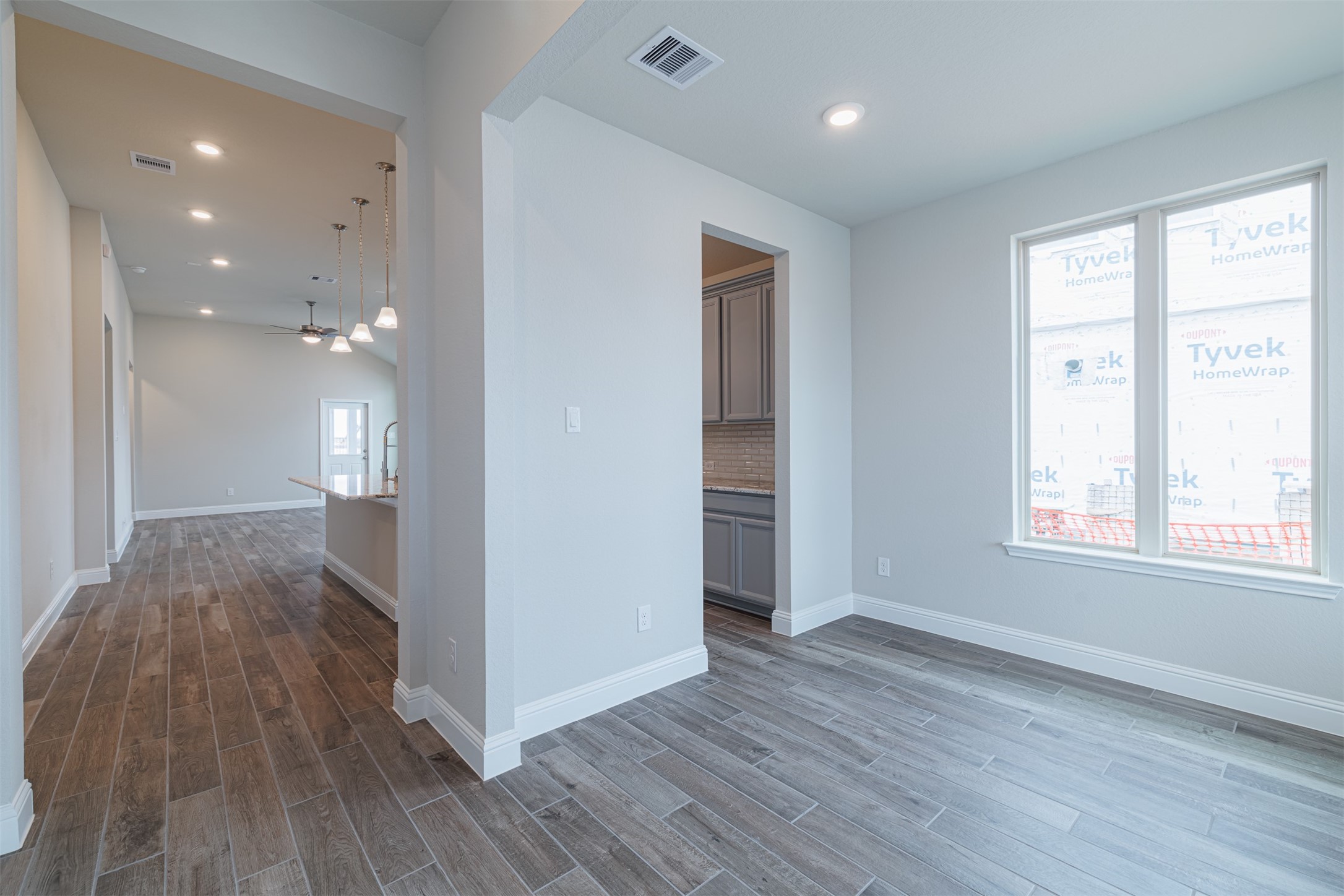 12611 White Pelican Court Cypress, TX 77433 - Photo 5 of 24 a view of an empty room with wooden floor and a window