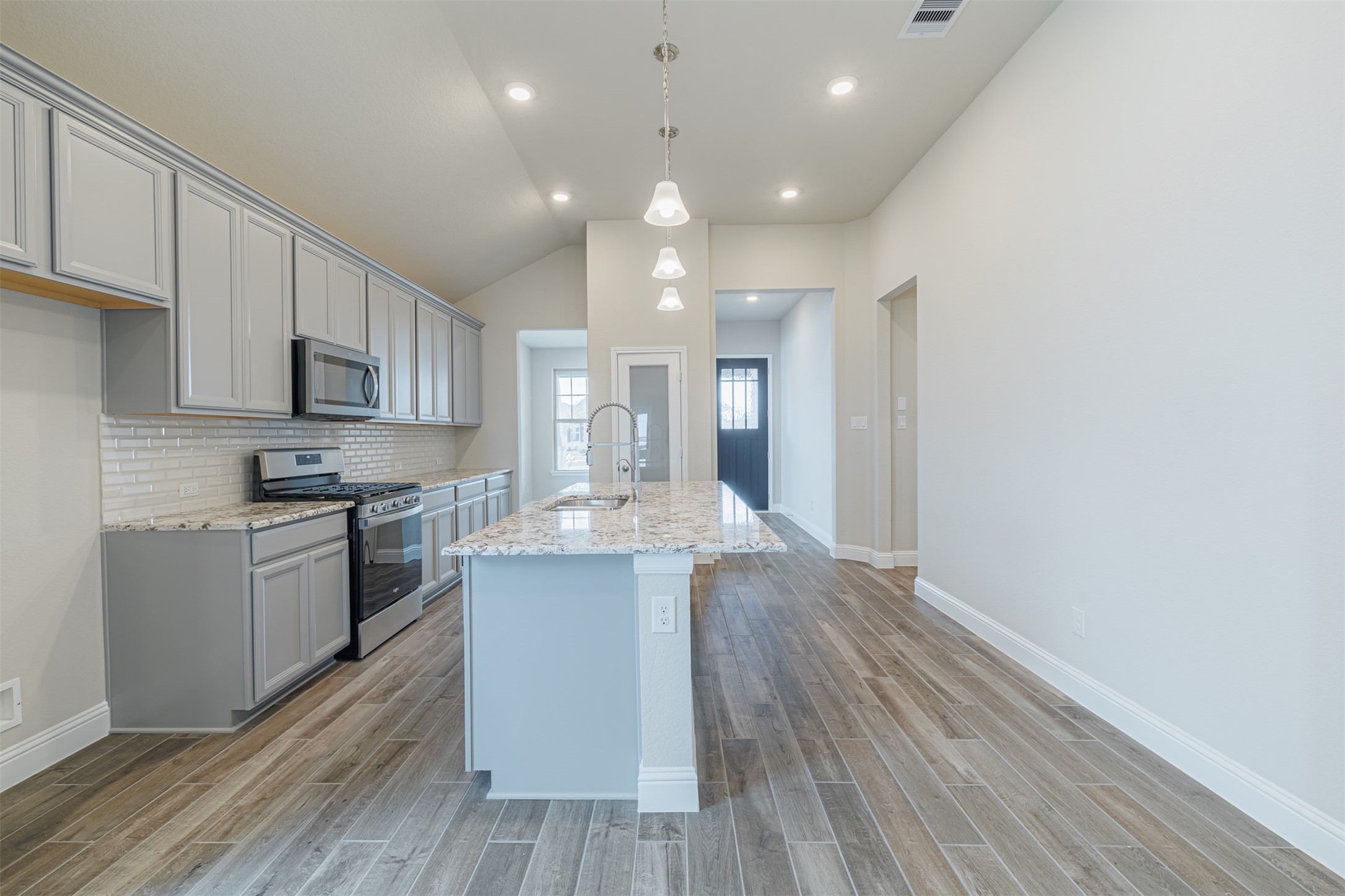 12611 White Pelican Court Cypress, TX 77433 - Photo 10 of 24 a kitchen with a sink microwave and cabinets