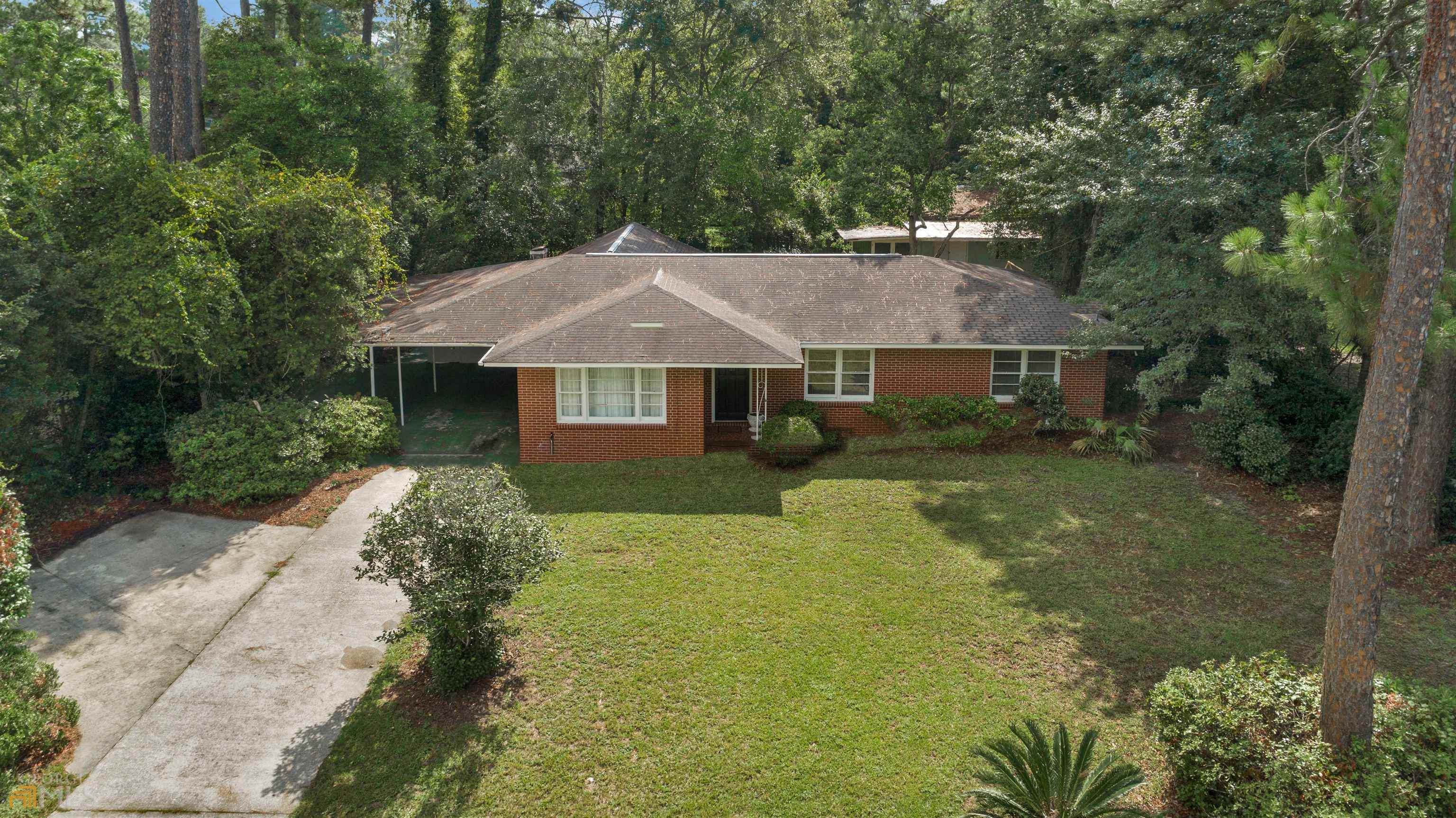136 Groveland Street Jesup, GA 31545 - Photo 1 of 1 a front view of a house with garden