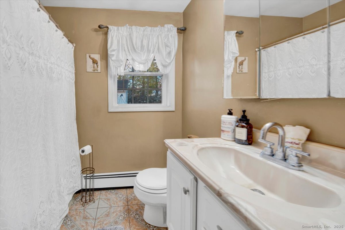 65 Clearview Drive Bridgeport, CT 06606 - Photo 13 of 25 a bathroom with a sink a toilet and mirror