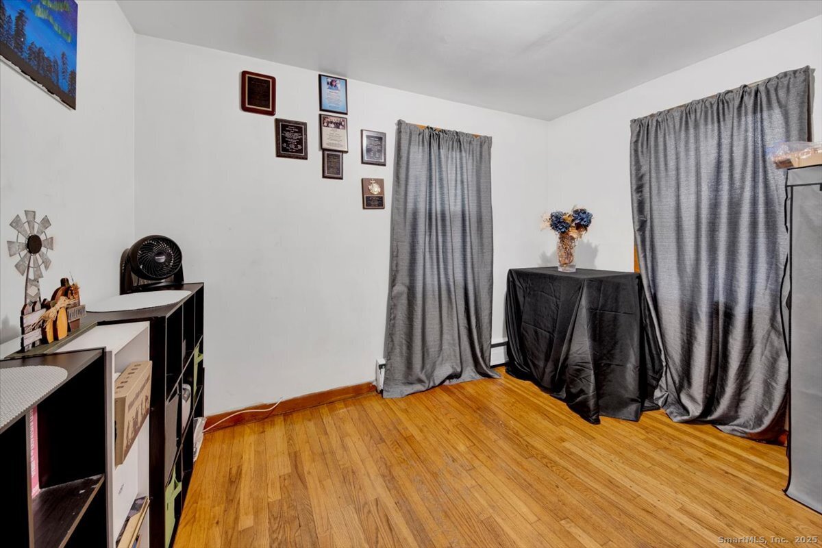 65 Clearview Drive Bridgeport, CT 06606 - Photo 14 of 25 a bed room with a bed and a chair