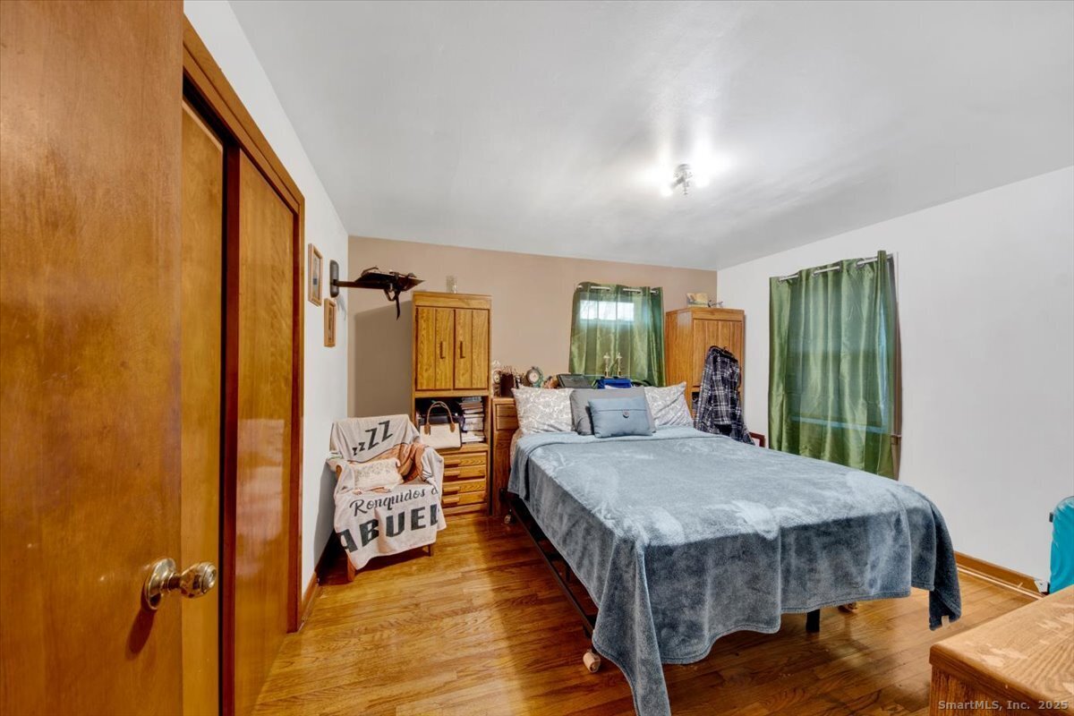 65 Clearview Drive Bridgeport, CT 06606 - Photo 15 of 25 a view of a bedroom with a bed and wooden floor