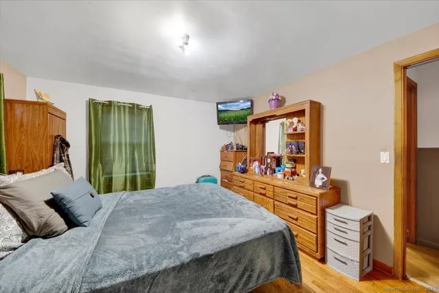 a bed room with a bed mirror and a desk