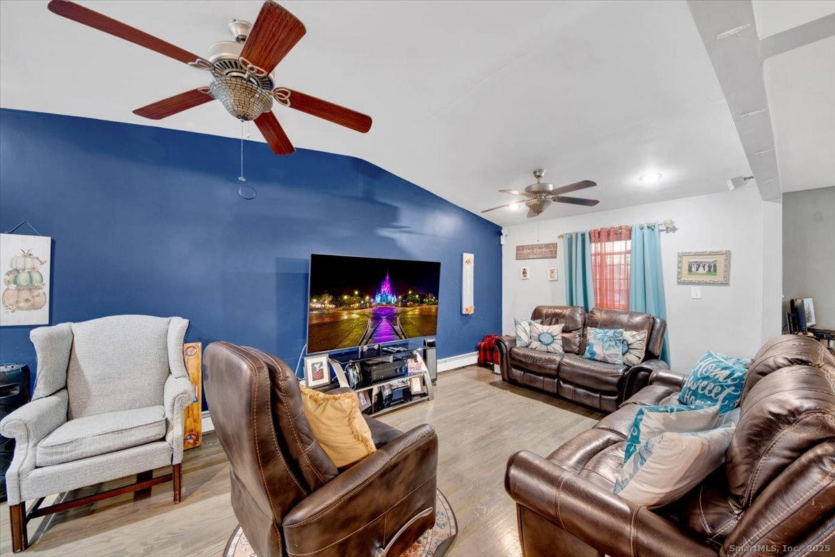 65 Clearview Drive Bridgeport, CT 06606 - Photo 20 of 25 a living room with furniture and a flat screen tv