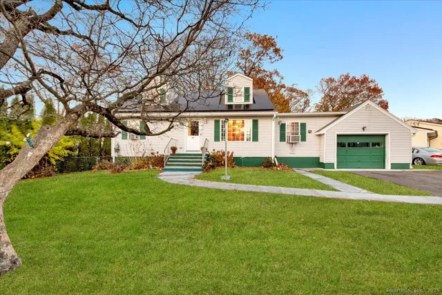 a front view of house with yard and green space