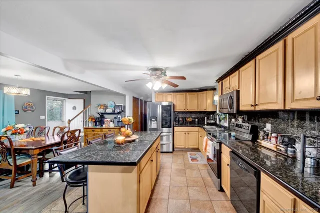 a living room with lots of furniture and kitchen view