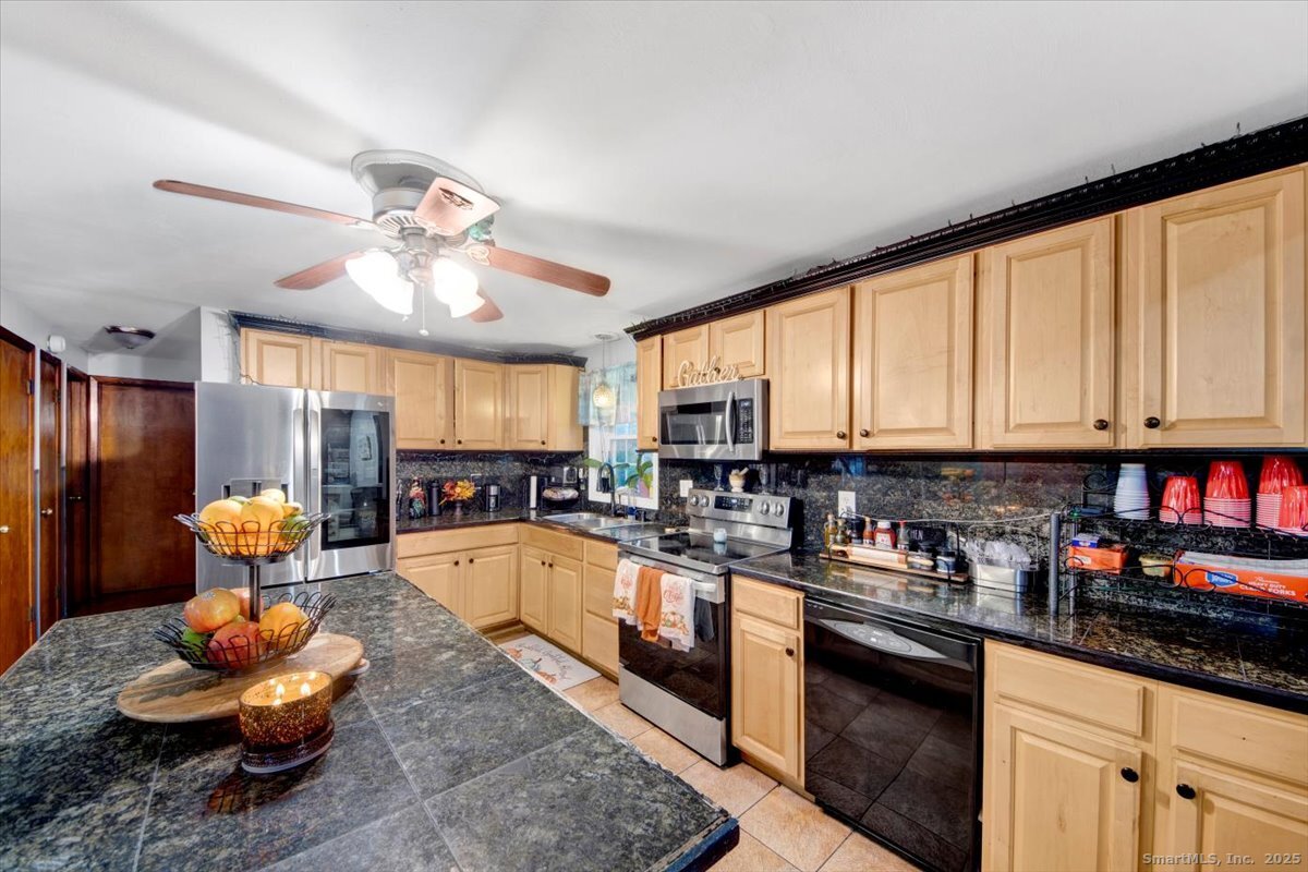 65 Clearview Drive Bridgeport, CT 06606 - Photo 25 of 25 a kitchen with stainless steel appliances granite countertop a sink dishwasher stove and refrigerator with wooden floor