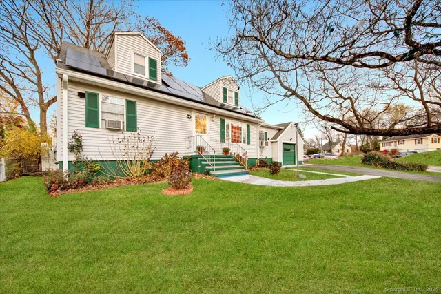 a view of a house with a backyard