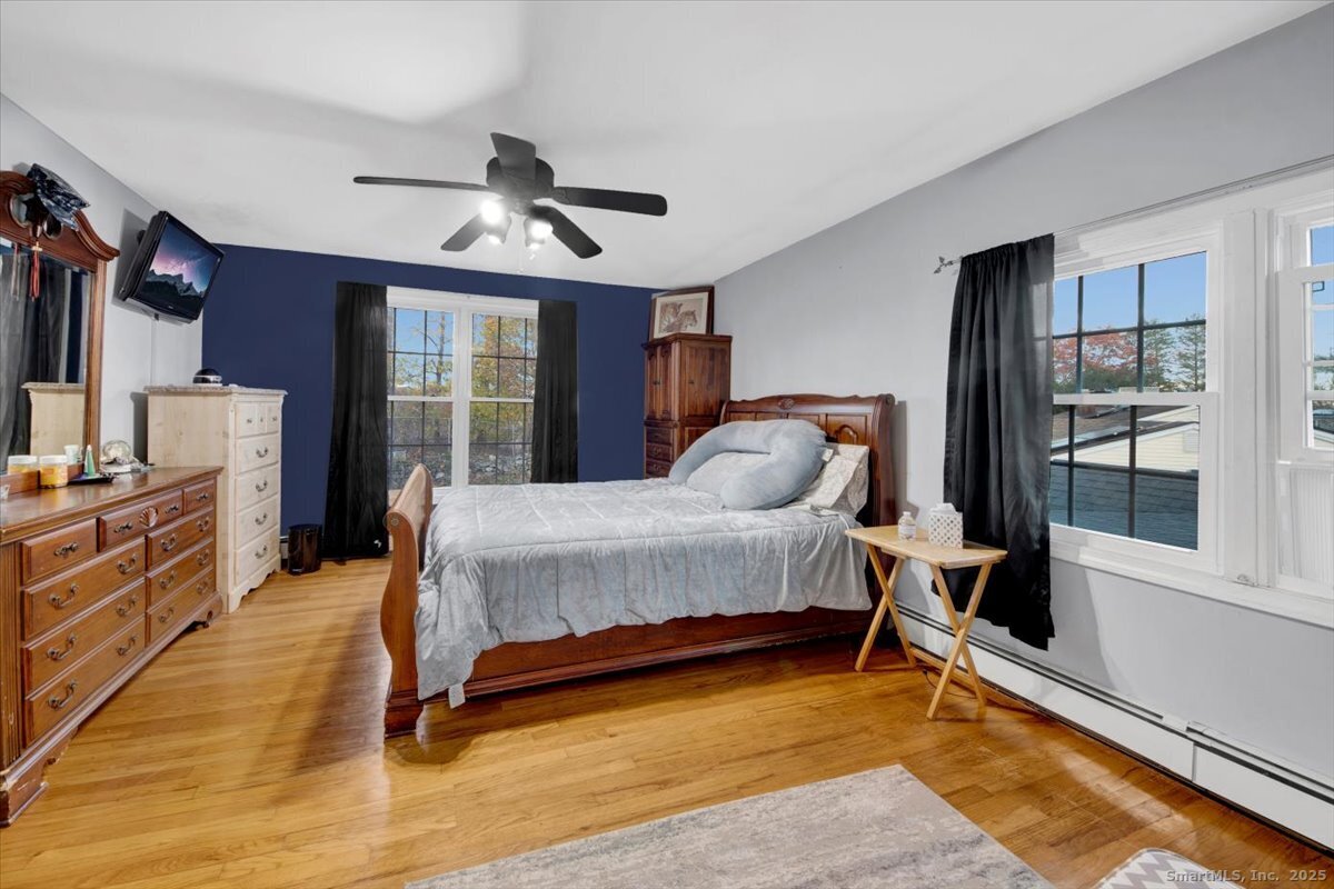 65 Clearview Drive Bridgeport, CT 06606 - Photo 10 of 25 a spacious bedroom with a bed a window and walk in closet