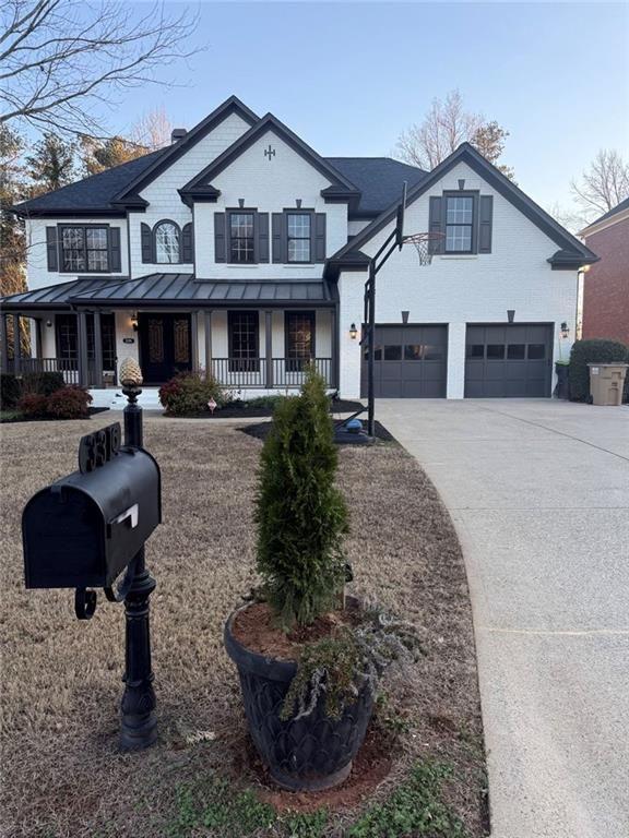 a front view of a house with garden and parking