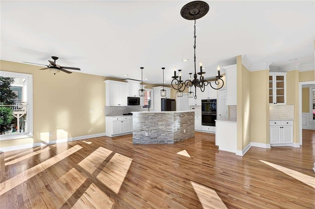 3316 Keenland Road Marietta, GA 30062 - Photo 15 of 57 a living room with kitchen island furniture and a chandelier