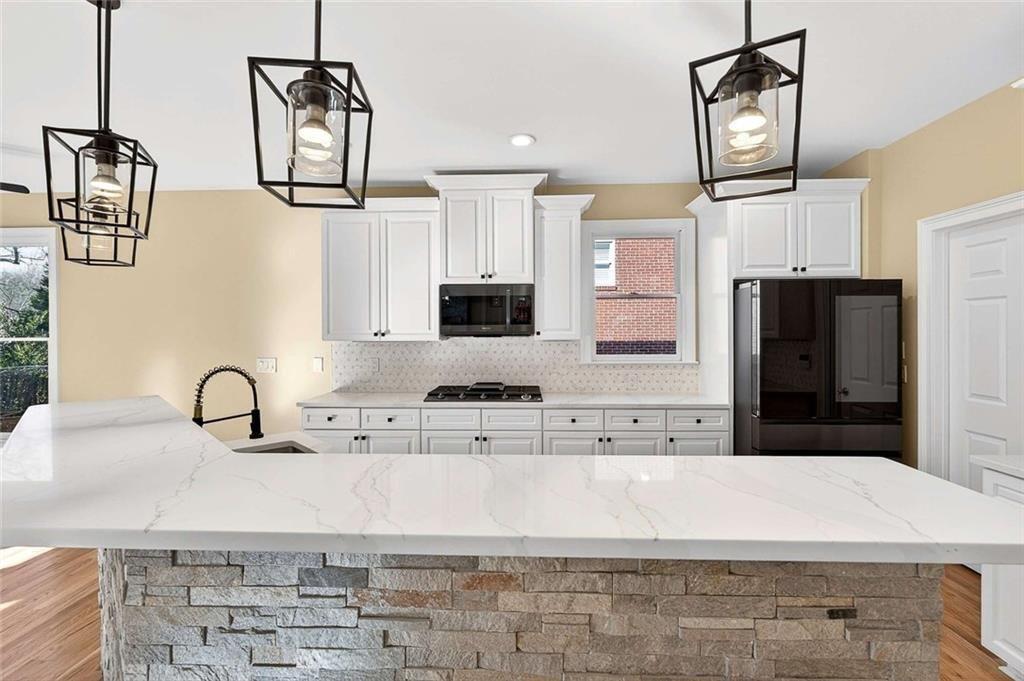 3316 Keenland Road Marietta, GA 30062 - Photo 18 of 57 a kitchen with kitchen island granite countertop a sink stainless steel appliances and cabinets