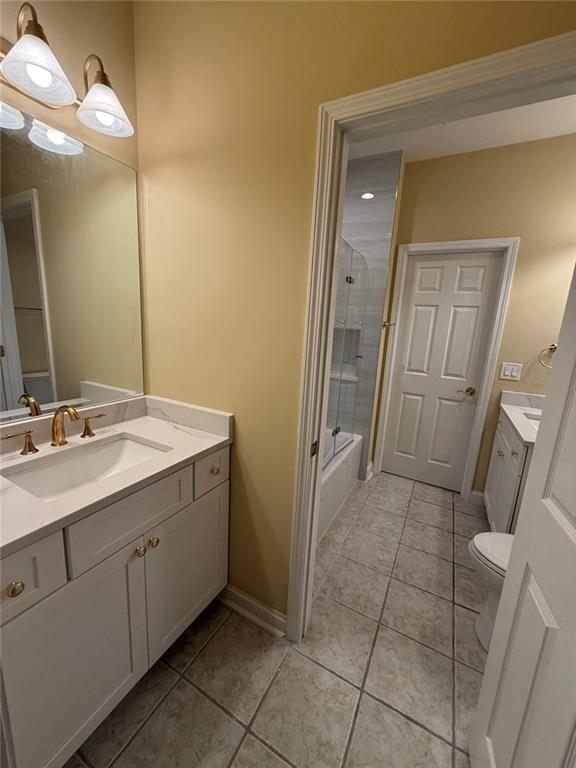 3316 Keenland Road Marietta, GA 30062 - Photo 23 of 54 a bathroom with a sink a toilet a mirror and vanity
