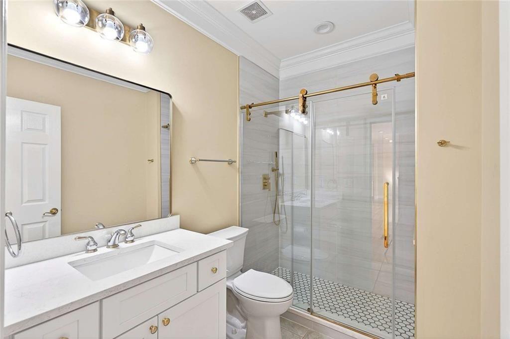 3316 Keenland Road Marietta, GA 30062 - Photo 27 of 57 a bathroom with a sink a toilet and shower