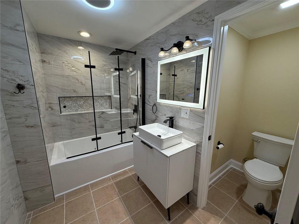 3316 Keenland Road Marietta, GA 30062 - Photo 38 of 54 a bathroom with a toilet a sink and shower