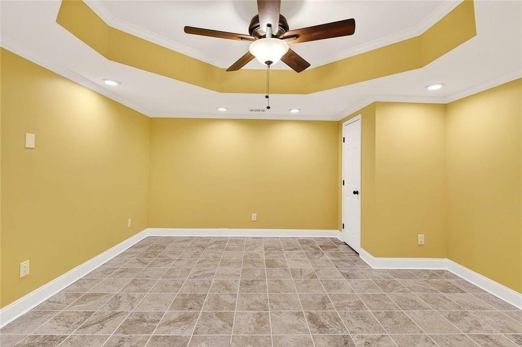 3316 Keenland Road Marietta, GA 30062 - Photo 44 of 57 a view of a big room with wooden floor and a ceiling fan