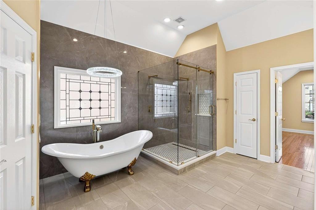 3316 Keenland Road Marietta, GA 30062 - Photo 8 of 57 a spacious bathroom with a tub shower and window