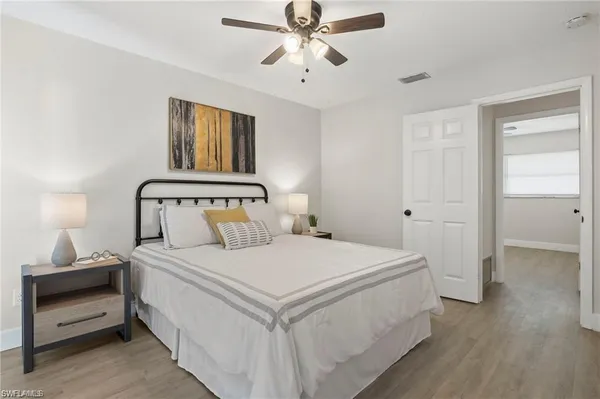 a bedroom with a bed and a chandelier