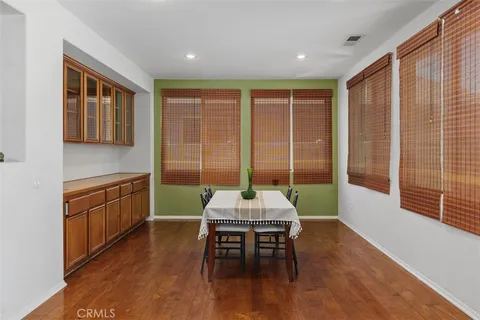 a kitchen with a table chairs sink and cabinets