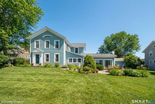 a front view of a house with a garden