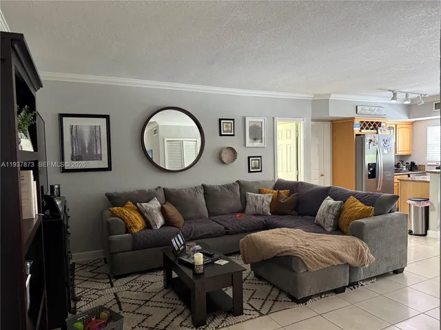 a living room with furniture a mirror and a lamp