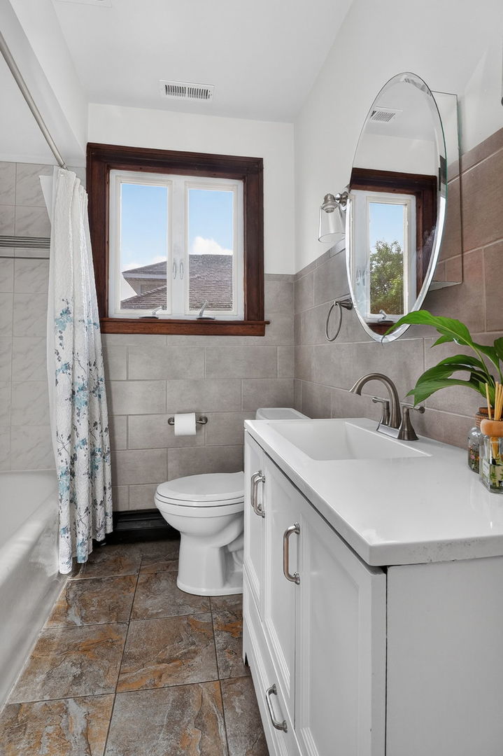 708 McCarthy Road Lemont, IL 60439 - Photo 12 of 14 a bathroom with a toilet sink and mirror