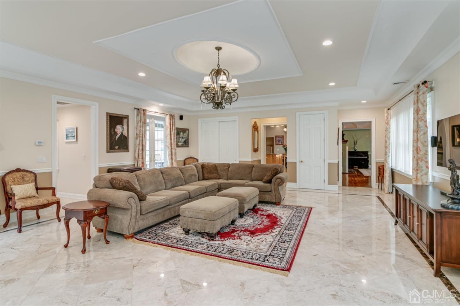 4 Longview Road Edison, NJ 08820 - Photo 15 of 47 a living room with furniture a chandelier and a rug