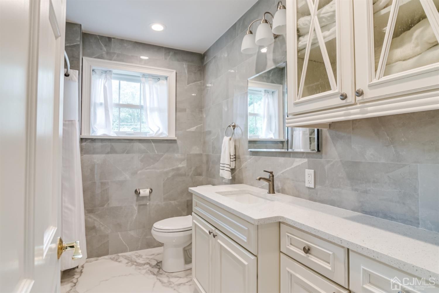 4 Longview Road Edison, NJ 08820 - Photo 23 of 47 a bathroom with a sink a toilet and a window
