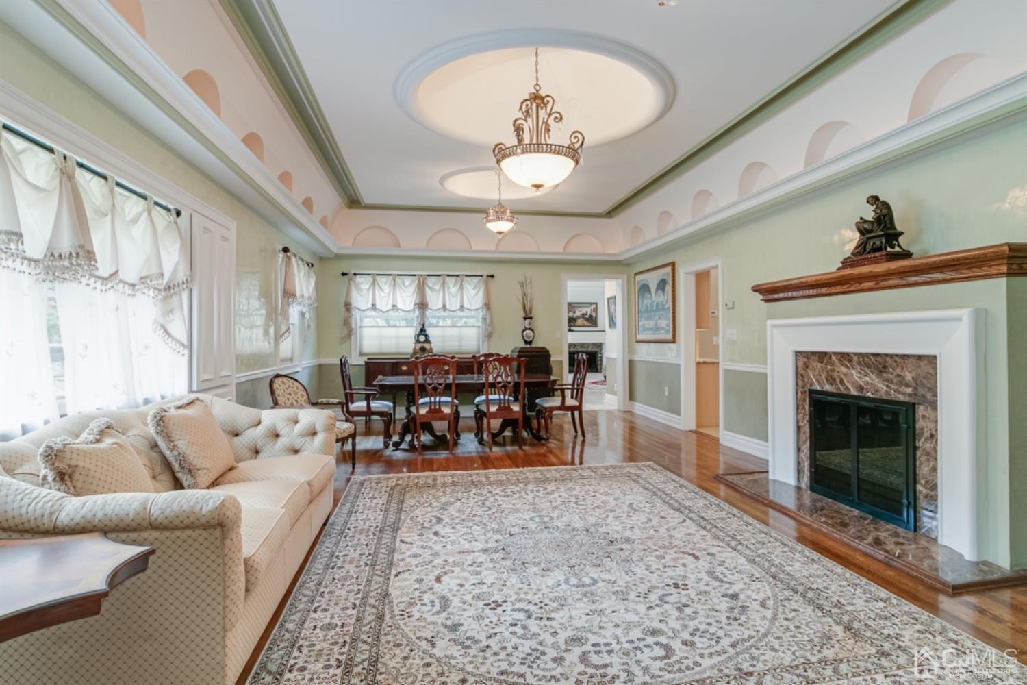 4 Longview Road Edison, NJ 08820 - Photo 6 of 47 a living room with furniture a chandelier and a fireplace
