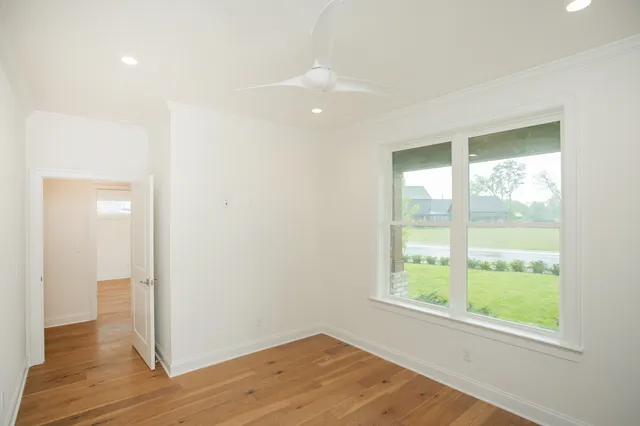 a view of a livingroom with wooden floor and window